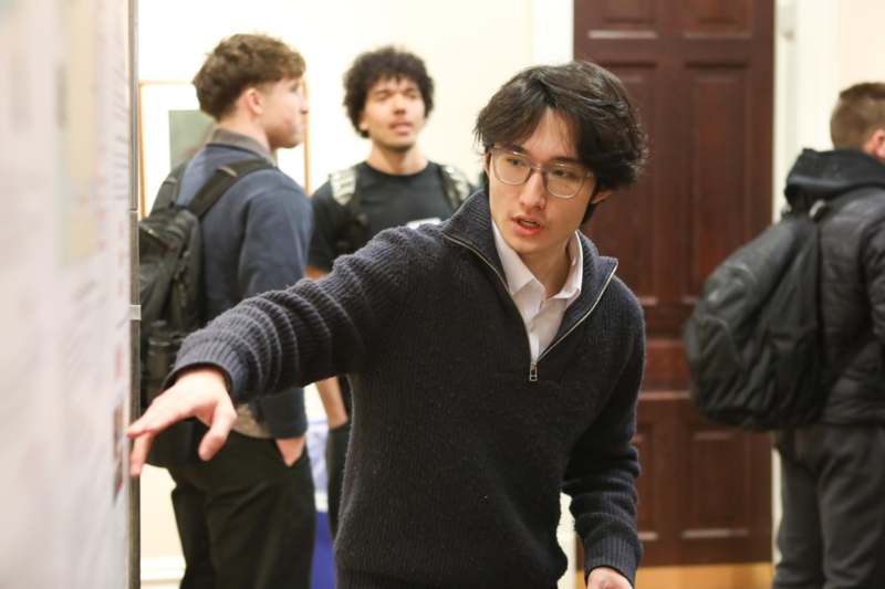 a man in a sweater and glasses