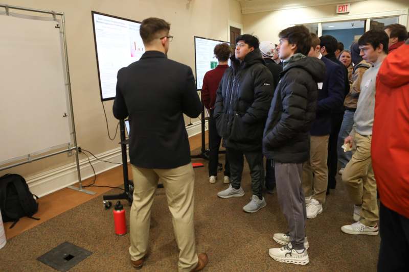 a group of people standing in front of a screen