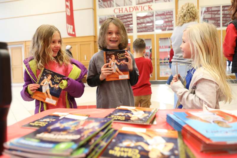 Basketball vs. John Carroll, January 24, 2026 - a group of children holding books