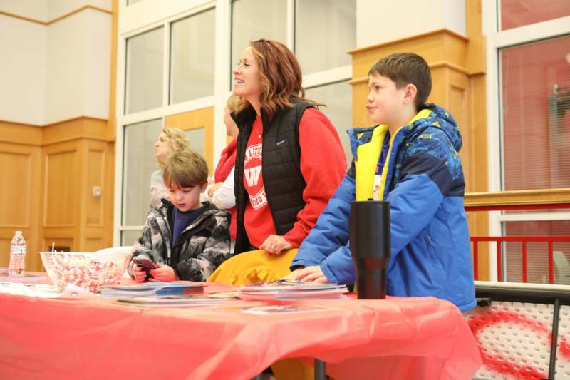a woman and two children sitting at a table