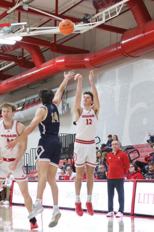 a group of men playing basketball