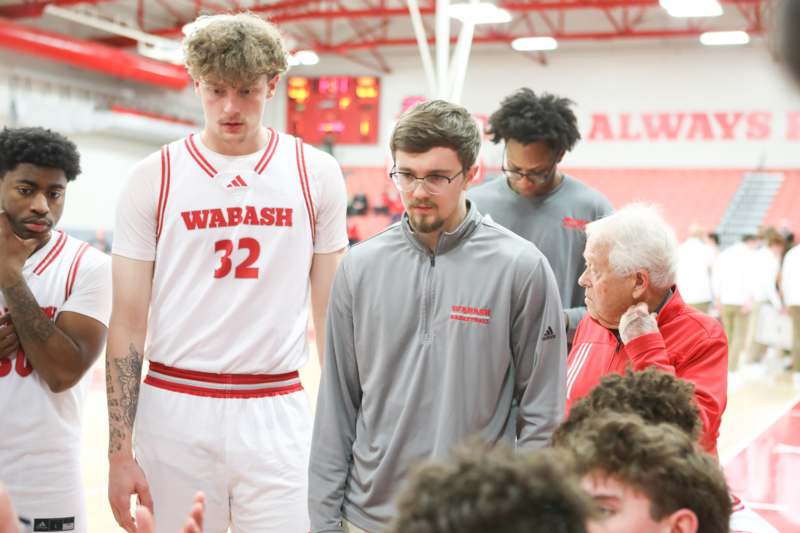 a group of men in a basketball court
