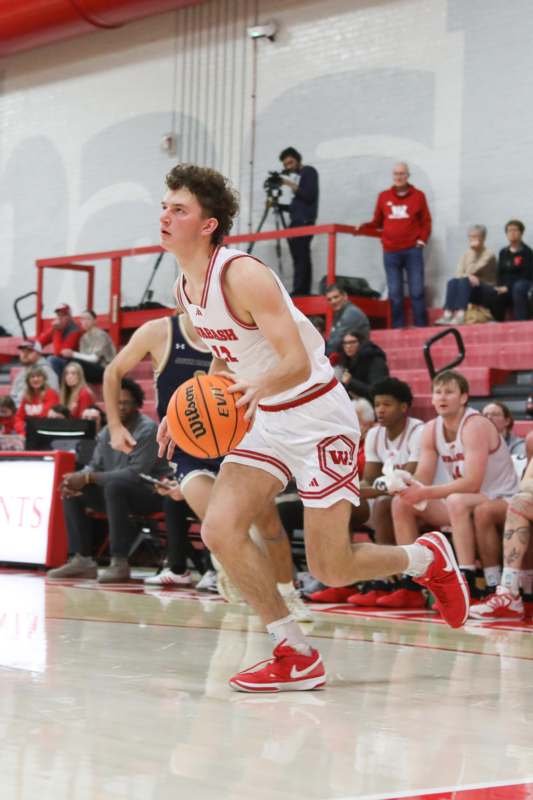 a man in a basketball uniform dribbling a basketball