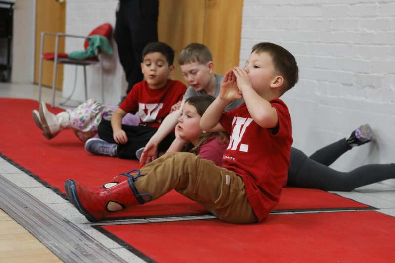 a group of children sitting on the floor