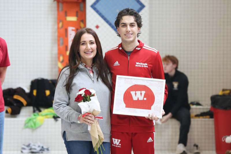 a man and woman holding flowers and a picture