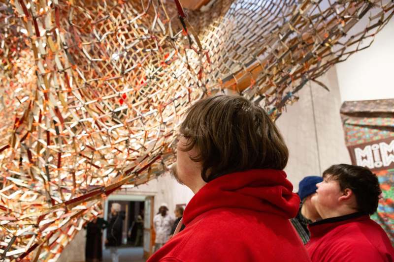 a group of people looking at a sculpture