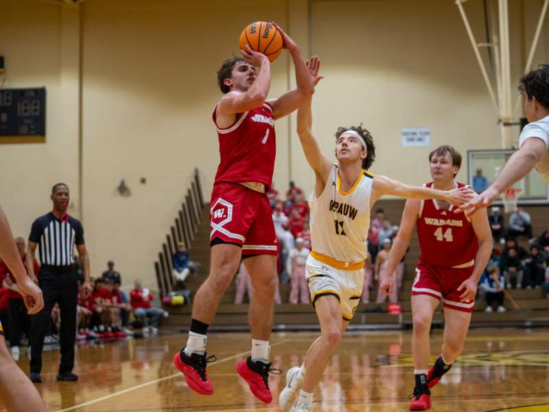 a group of men playing basketball
