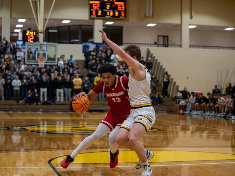 a basketball player in a gym with a ball in his hand