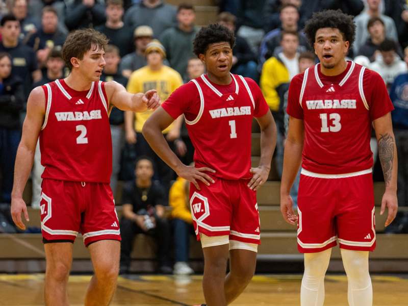 a group of men in red uniforms on a basketball court