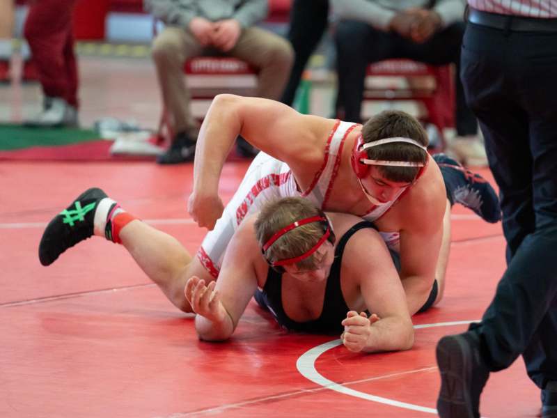 a two men wrestling on a mat