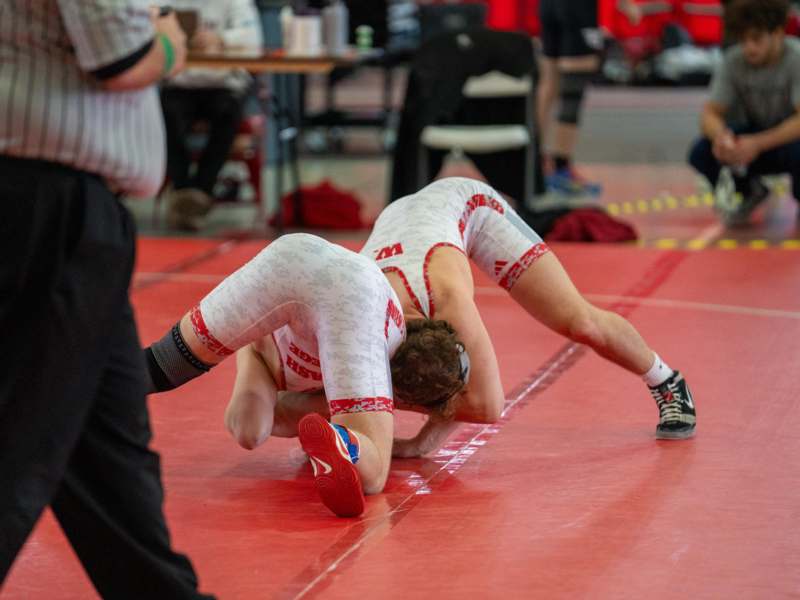a man in a wrestling suit on the floor