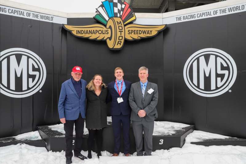 a group of people standing in front of a sign
