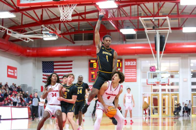 a group of people playing basketball