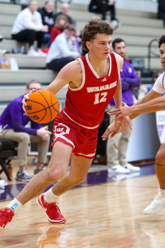 Basketball at Kenyon (1.17.26) - a man in a basketball uniform dribbling a basketball