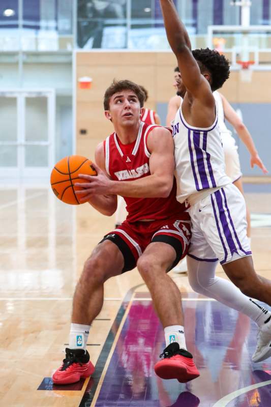 a basketball player in a red uniform with a ball in his hand