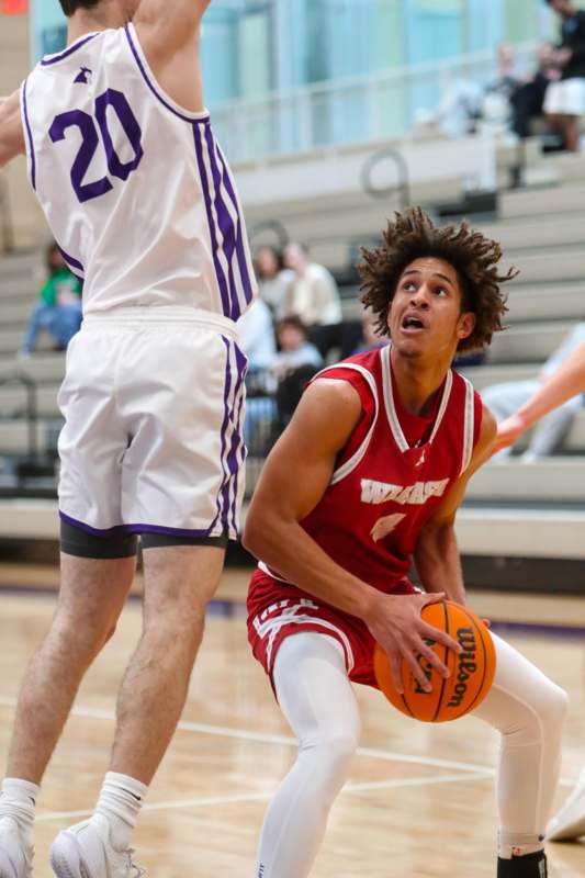a basketball player in a red uniform playing basketball