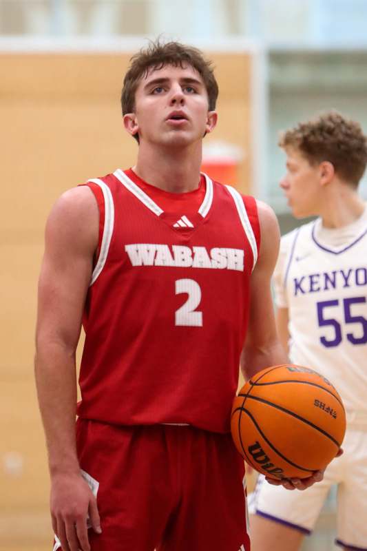 a man in a basketball uniform holding a basketball