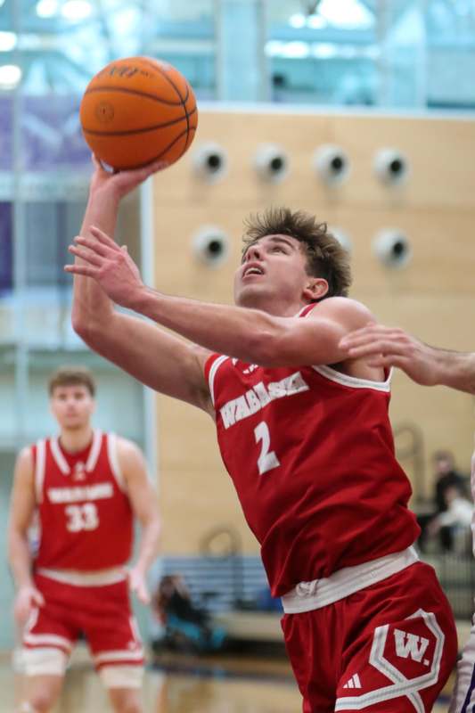 a man in a red uniform playing basketball