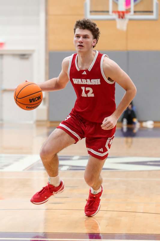 a man in a basketball uniform dribbling a basketball