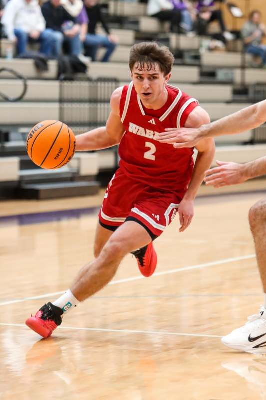 a man in a basketball uniform dribbling a basketball