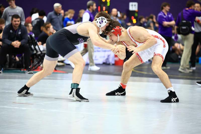two men wrestling on a mat