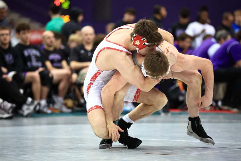 two men wrestling on a mat