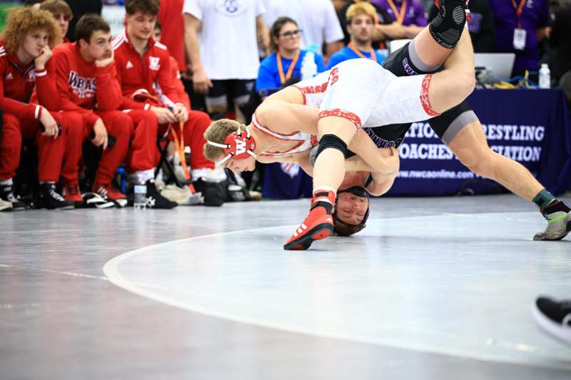 a man wrestling on the floor