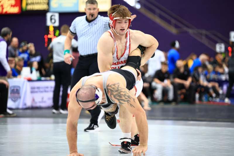 a man wrestling on the floor