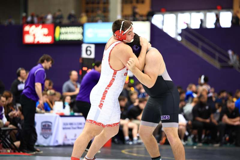 two men wrestling in a gym