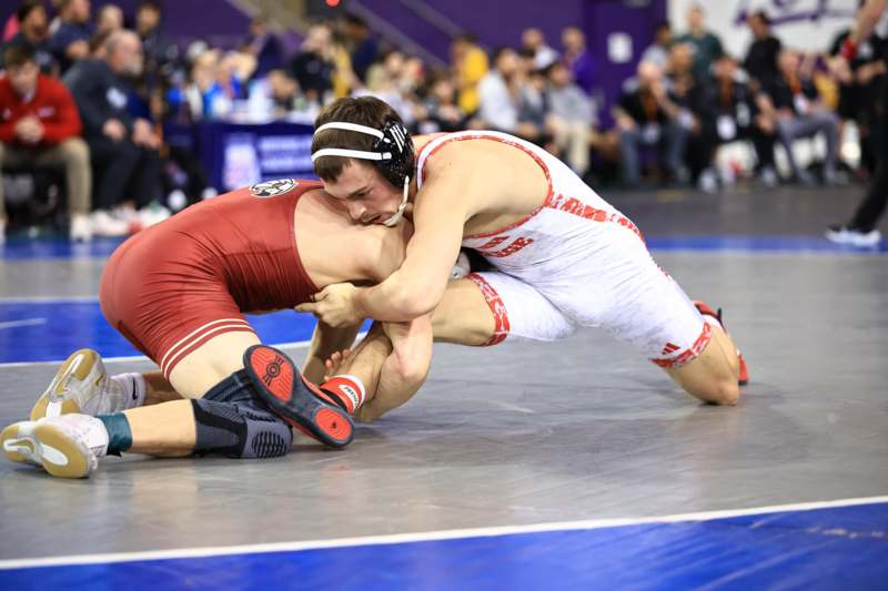 two men wrestling on a mat