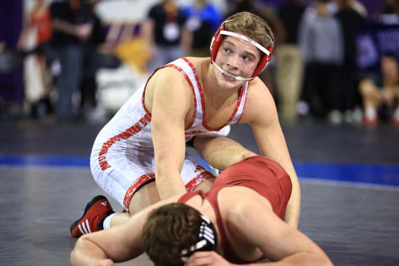 a man in a helmet wrestling another man in a helmet
