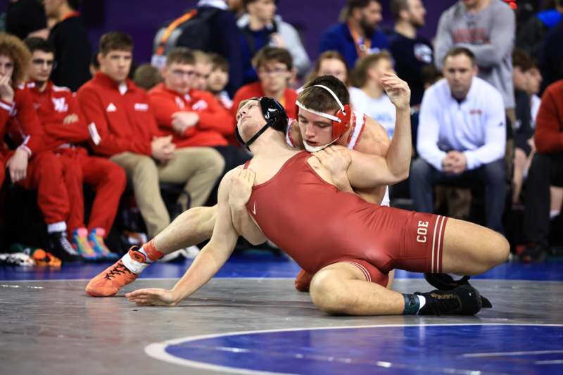 a man wrestling in a crowd