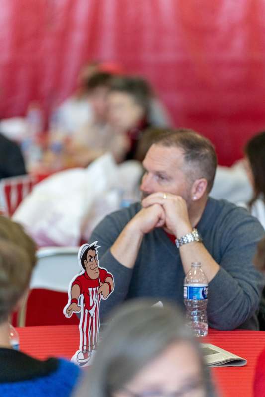 a man sitting at a table with a cartoon character