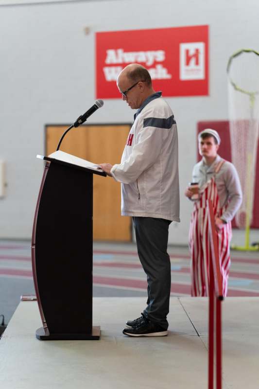 a man standing at a podium with a microphone