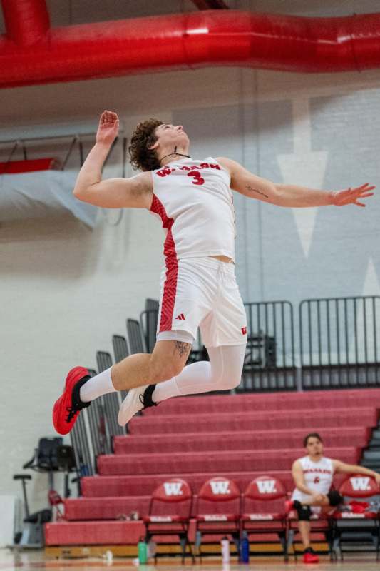 a man in a basketball uniform jumping in the air