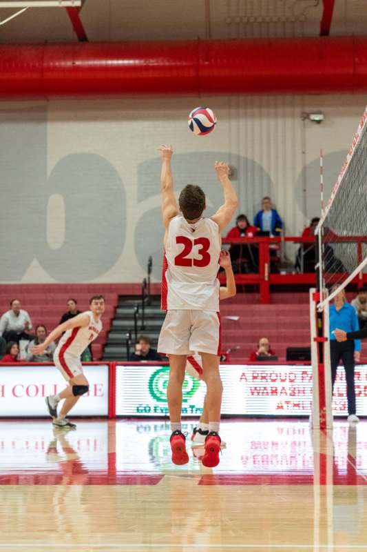 a man jumping up to hit a ball