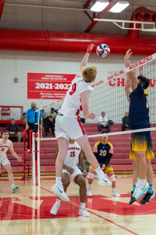 a group of men playing volleyball