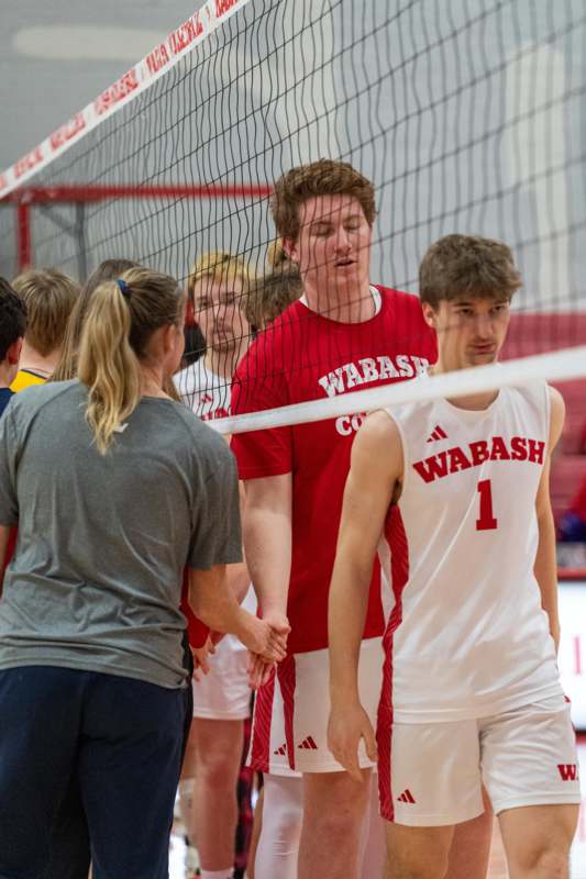 a group of people standing next to a net