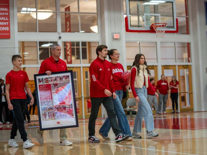 a group of people walking in a gym