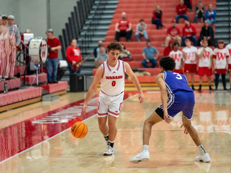 a basketball player dribbling a ball