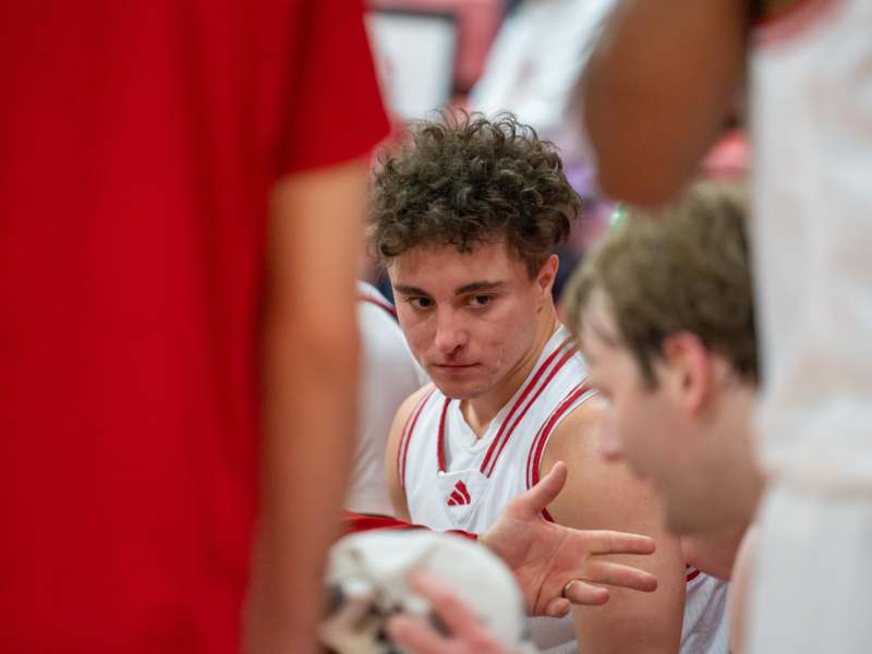 a group of men in a basketball uniform