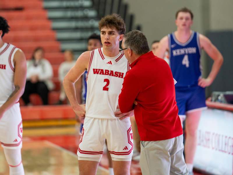 a basketball player talking to a coach