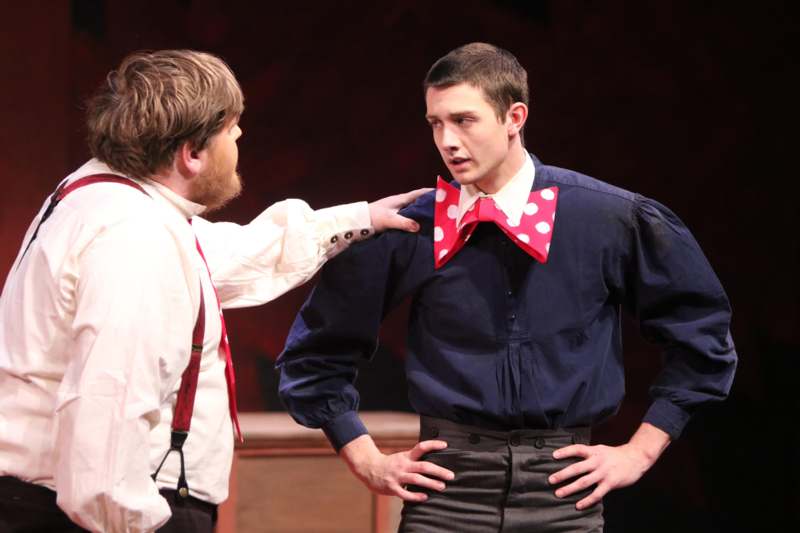 a man touching a man's shoulder