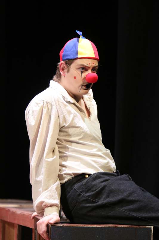 a man wearing a clown hat