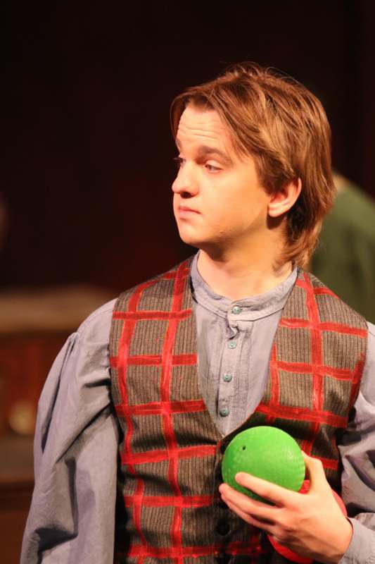 a man holding a green ball