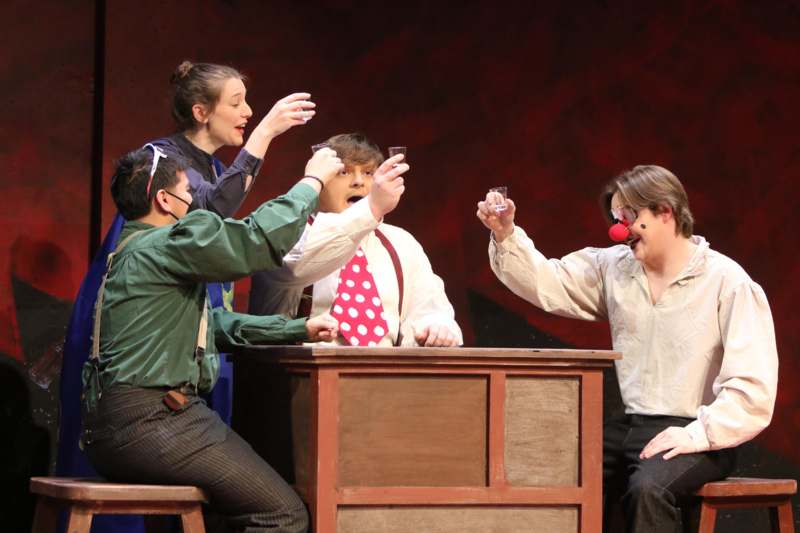 a group of people sitting at a table with clowns