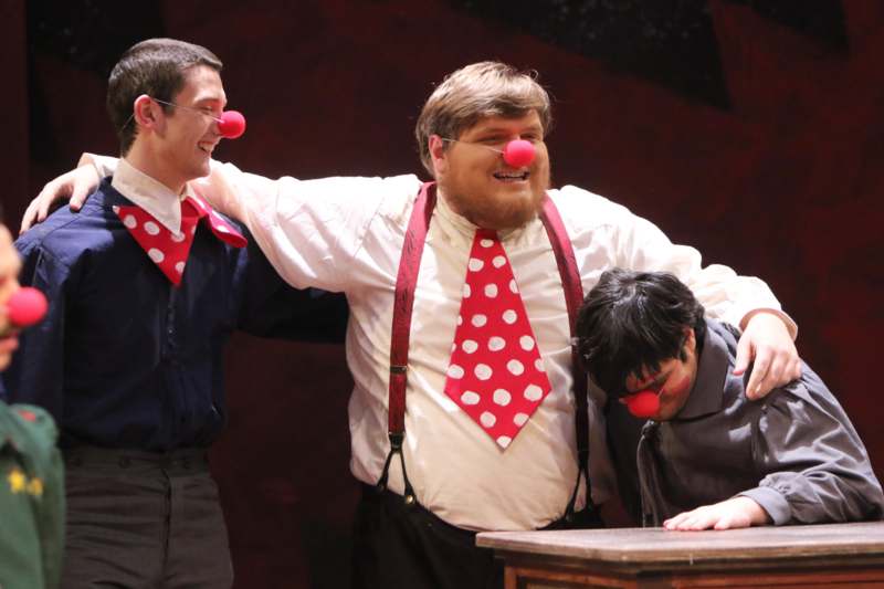 a group of men with red clown nose