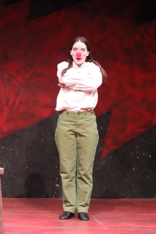 a woman with red nose on a stage