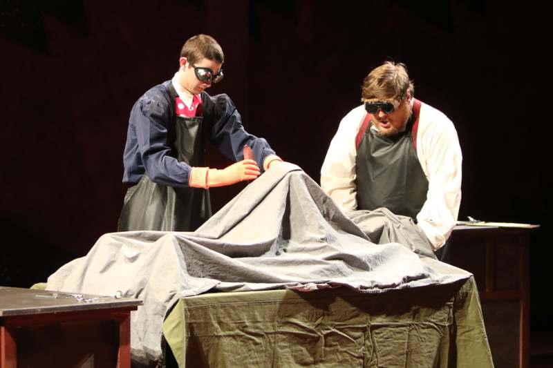 two men wearing goggles and aprons