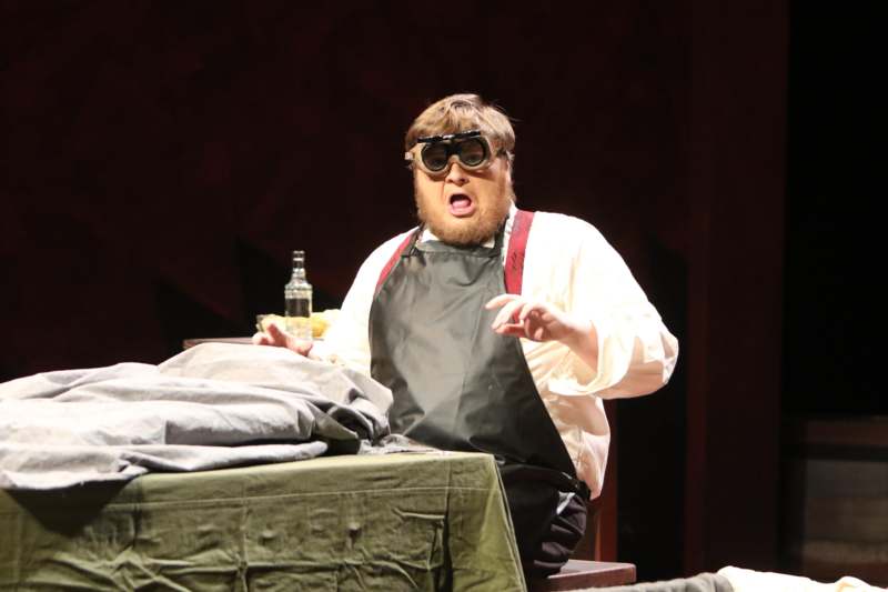 a man wearing goggles and apron